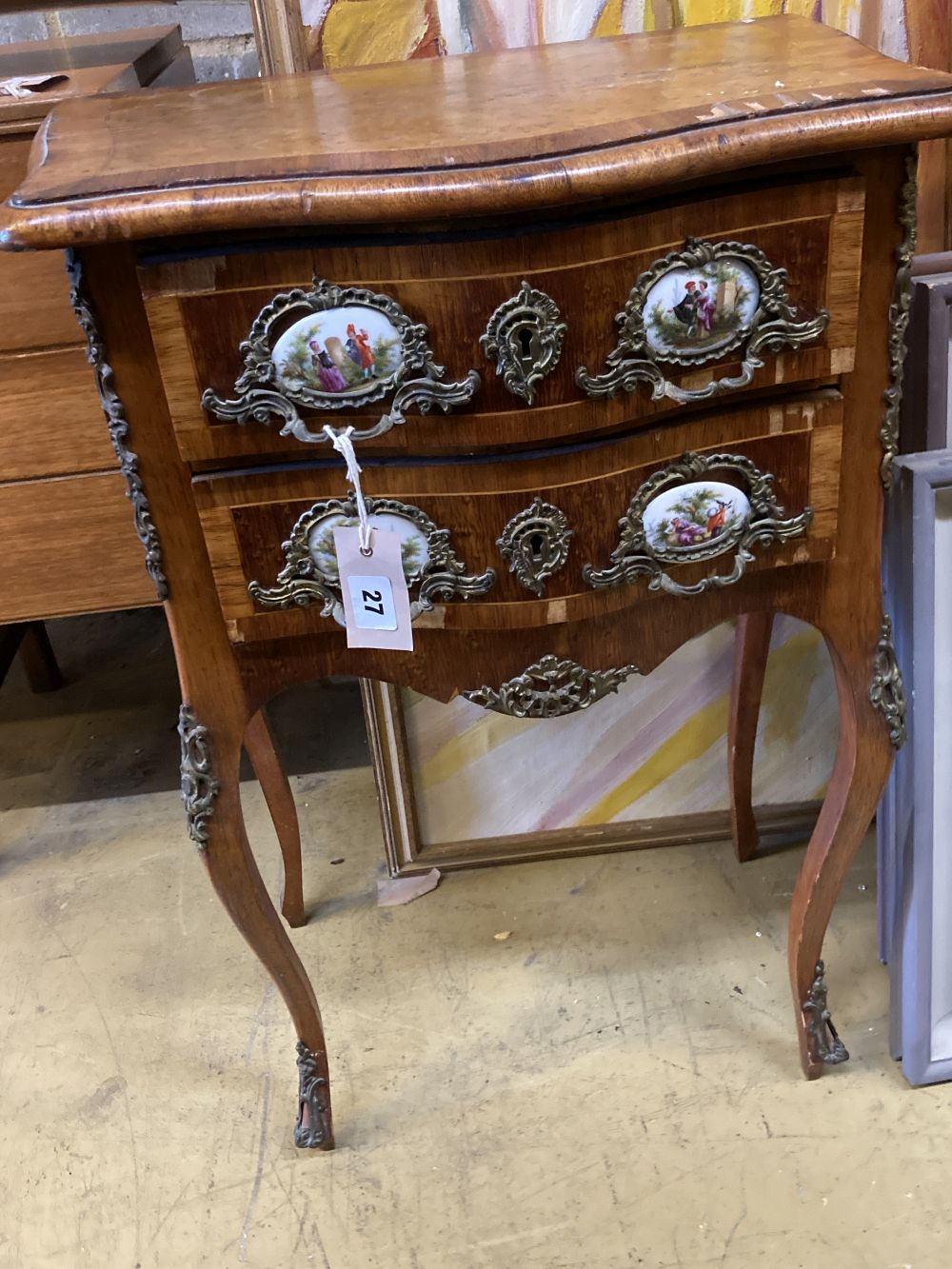 A French kingwood birds eye maple porcelain mounted serpentine two drawer bedside cabinet, width 50cm, depth 34cm, height 72cm